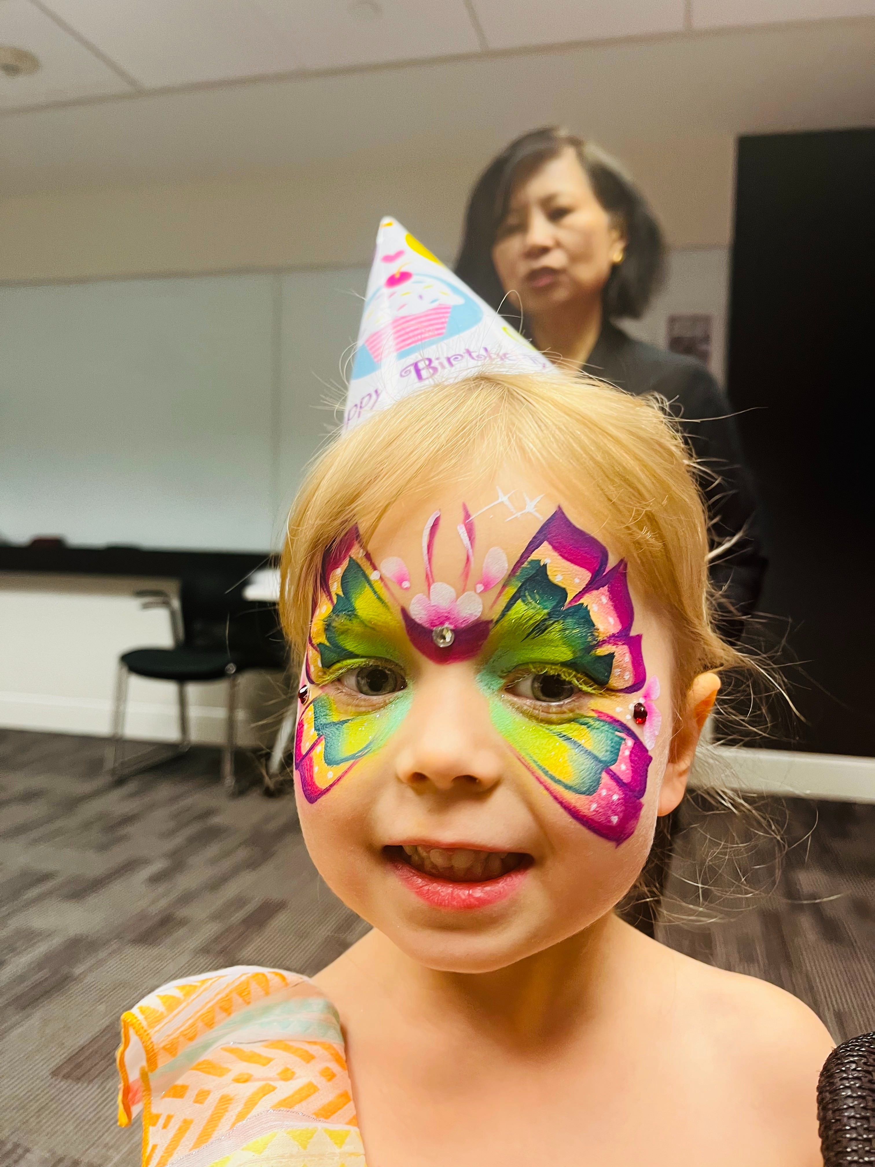 Child with colorful butterfly face paint